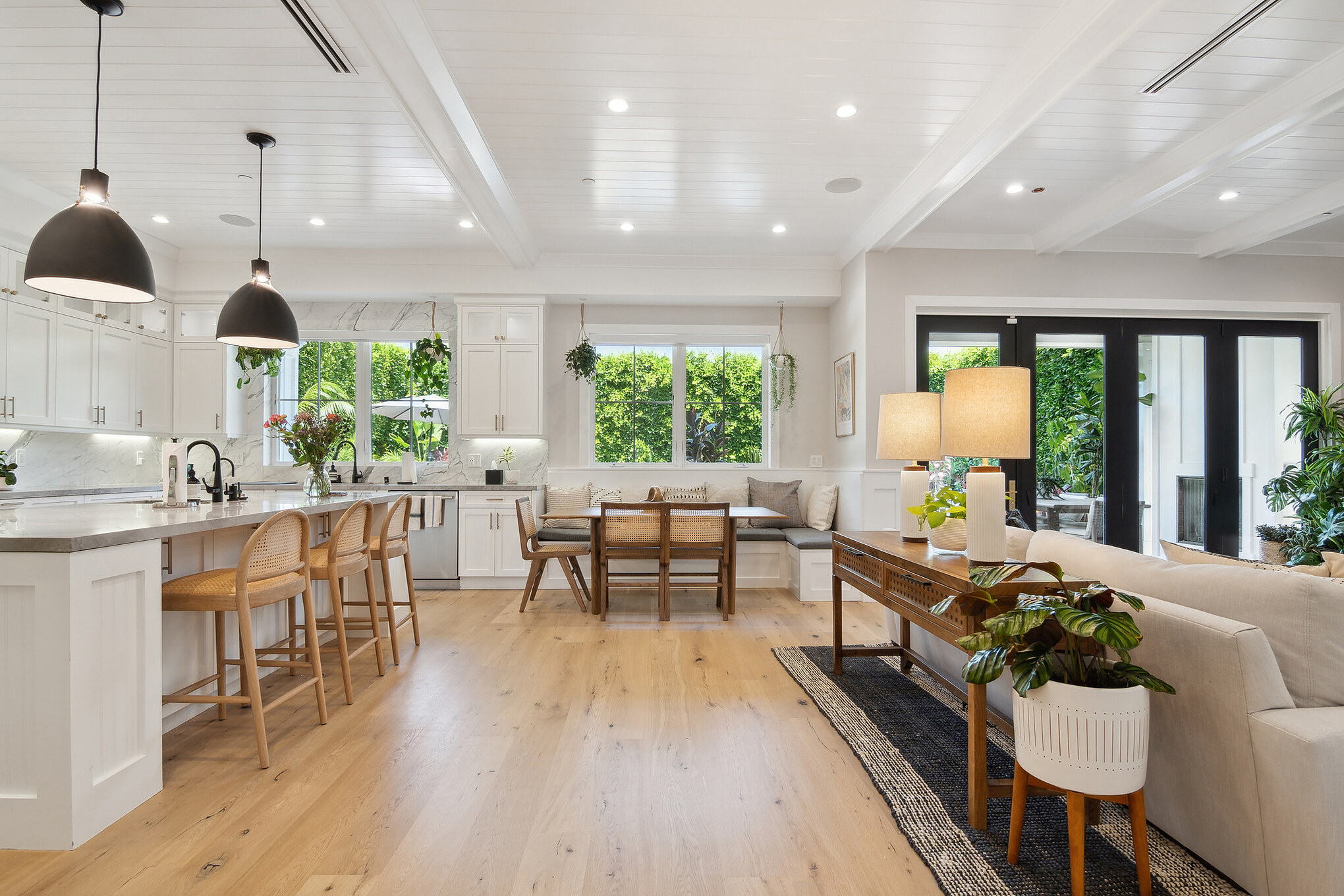 Los Angeles 806 open kitchen with white cabinets, island with bar stools, and pendant lights