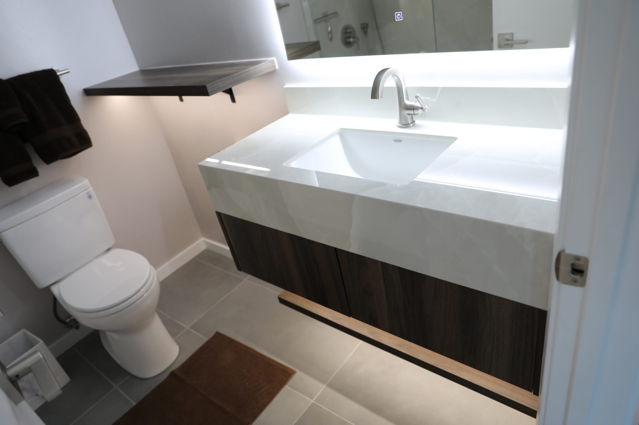 Guest bath walnut vanity and backlit mirror