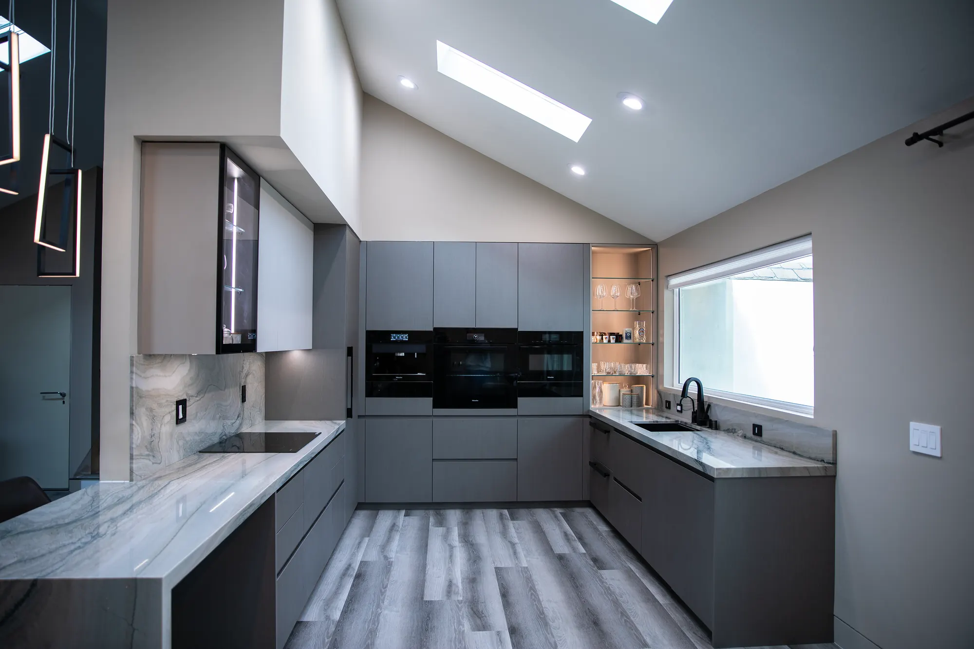 San Jose 6260 kitchen with grey cabinets, marble, and skylights