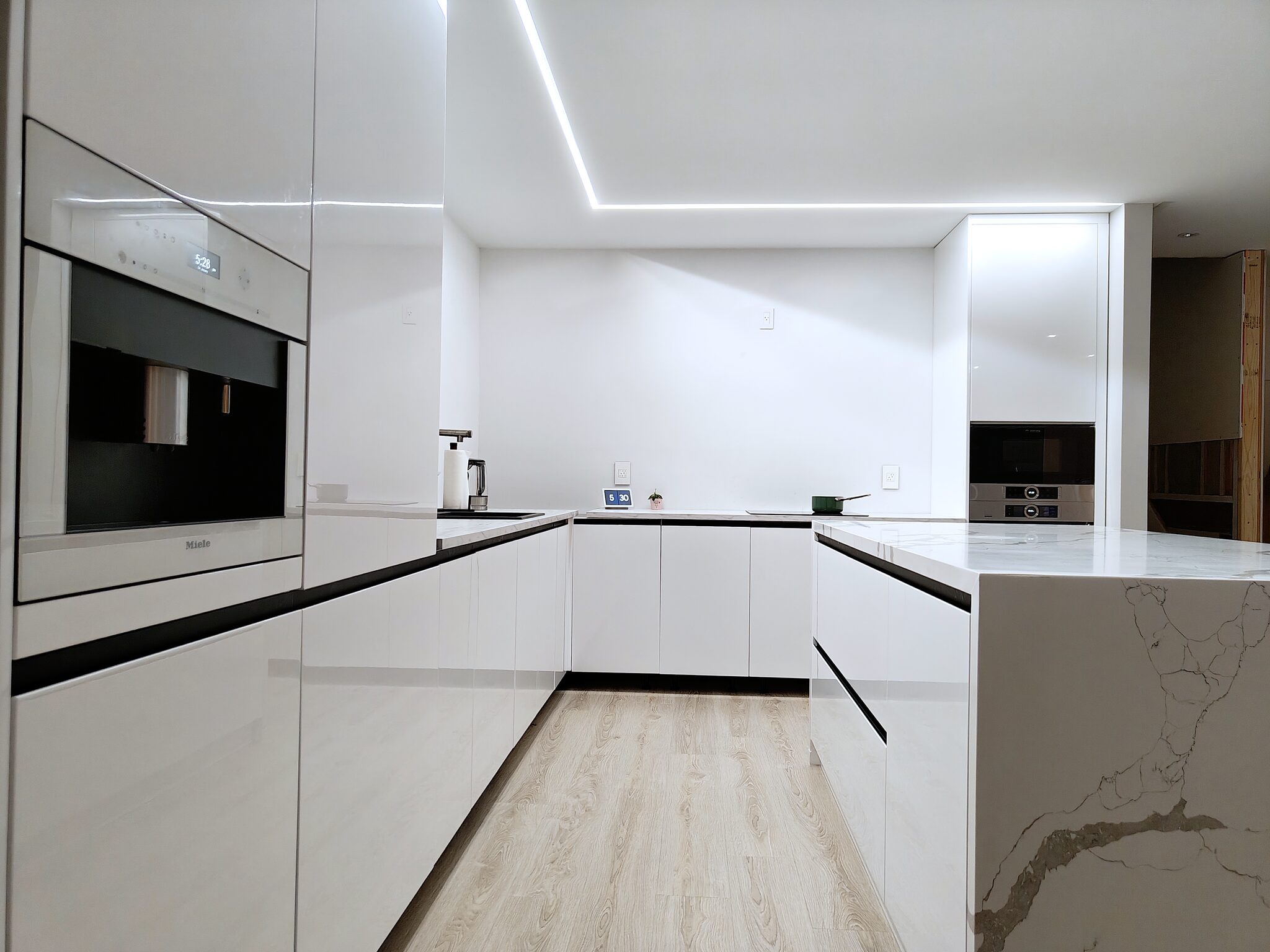 Galley looking past the Miele coffee machine to the ovens